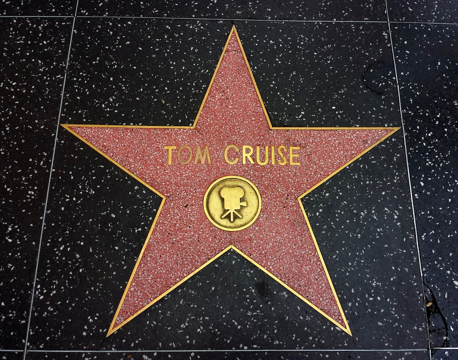 photo of Tom Cruises star on the Hollywood Walk of Fame. Star is outlined in gold and interior is rose colored marble with gold type