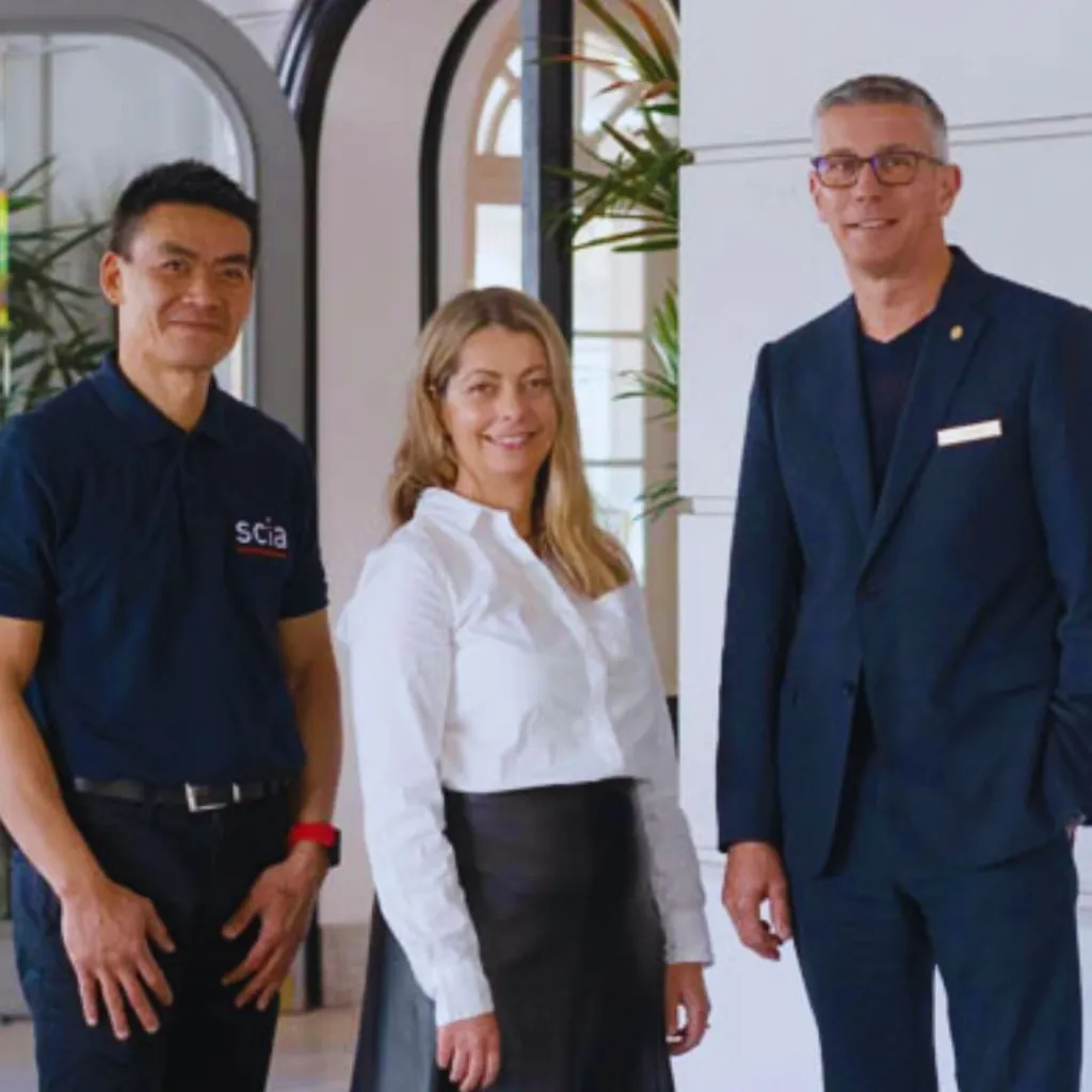 Photo of 3 unidentified IHG employees 2 men in blue uniforms with a woman wearing a white shirt in the center
